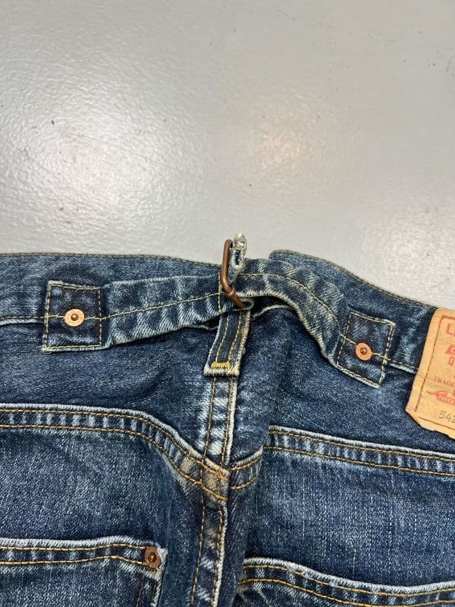 Vintage Levi’s Buckle Belt Denim Jeans | Size 36 | Blue Avant-Garde Pants — image 10 of 15